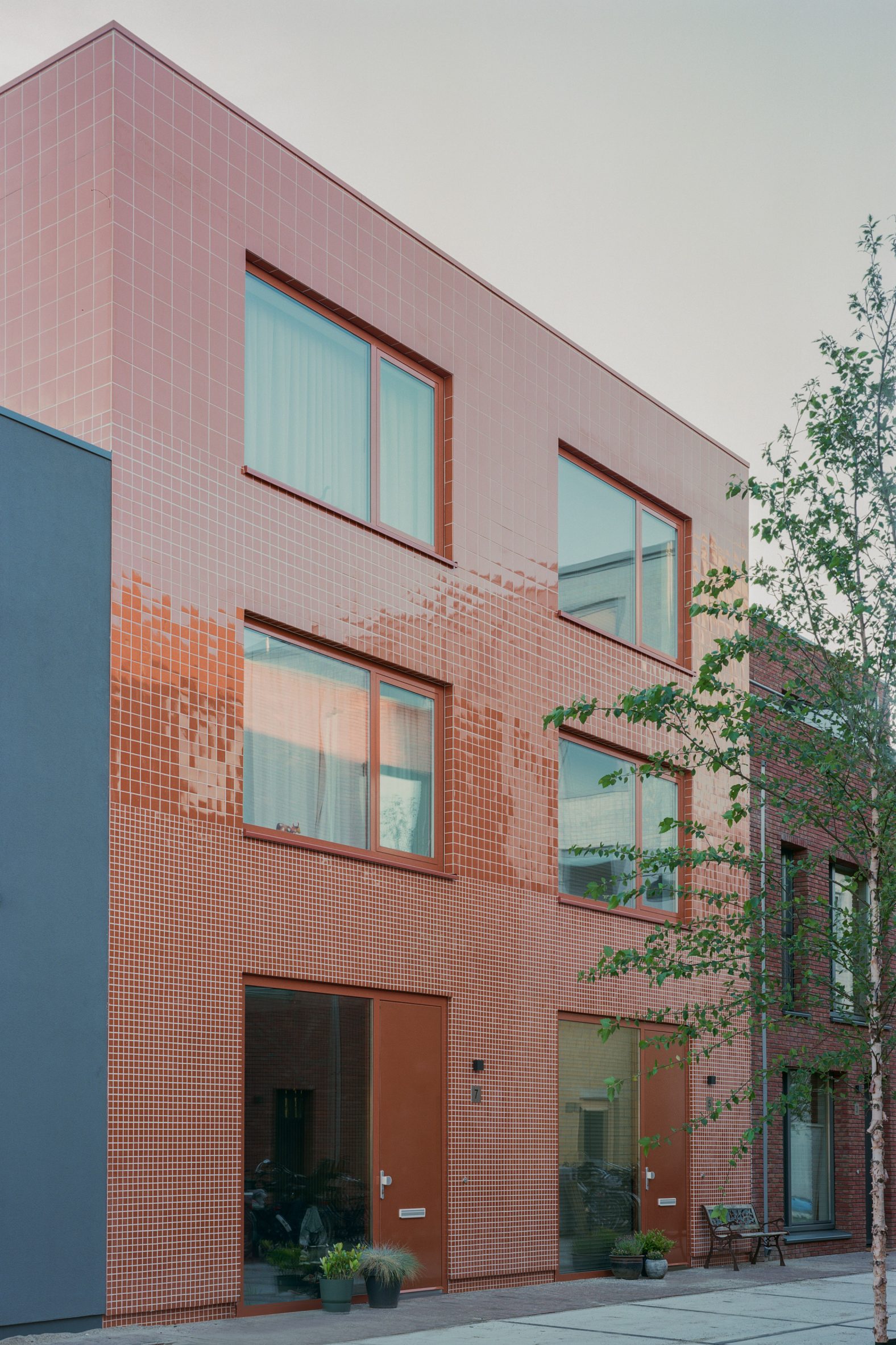Exterior image of a home in Utrecht with a glazed red tiled facade