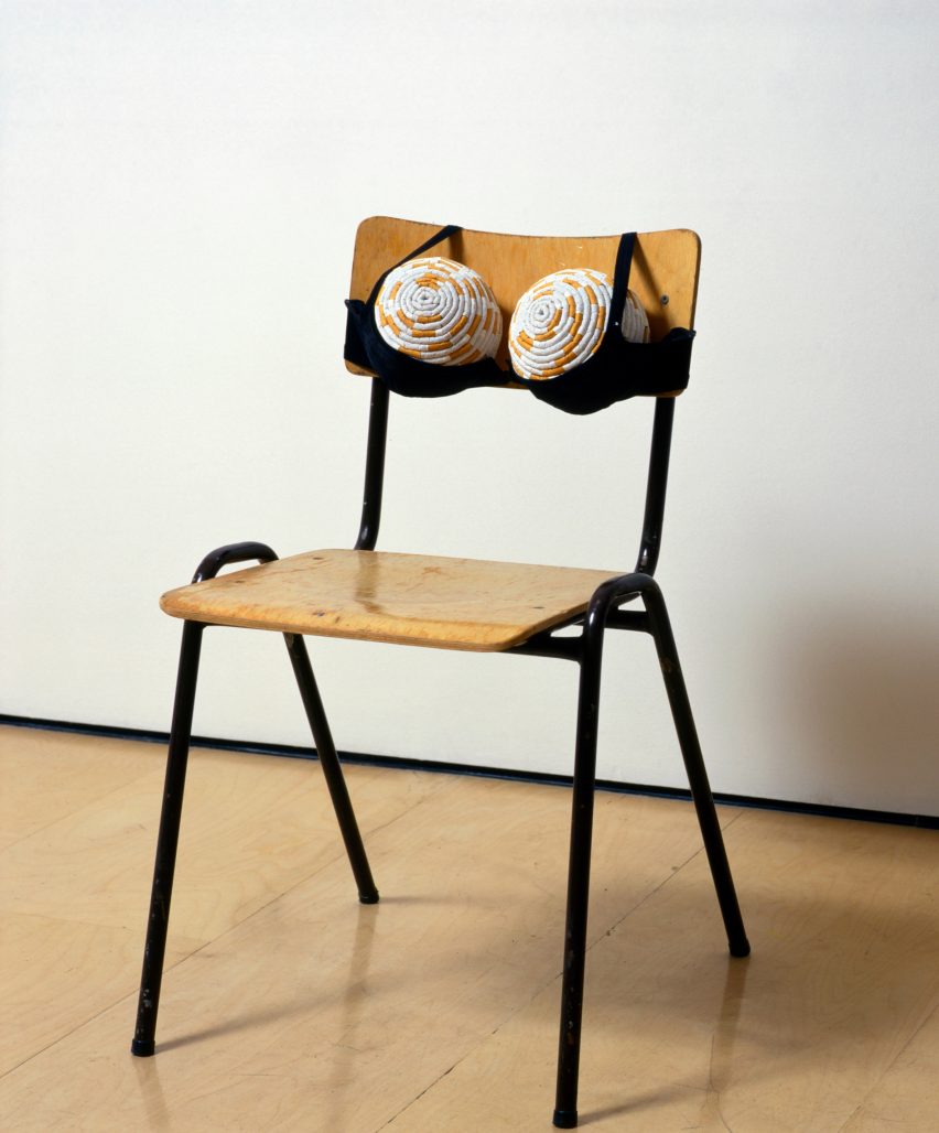 A chair with an upholstered bra on the back