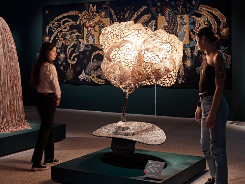 Visitors looking at a surrealist light sculpture