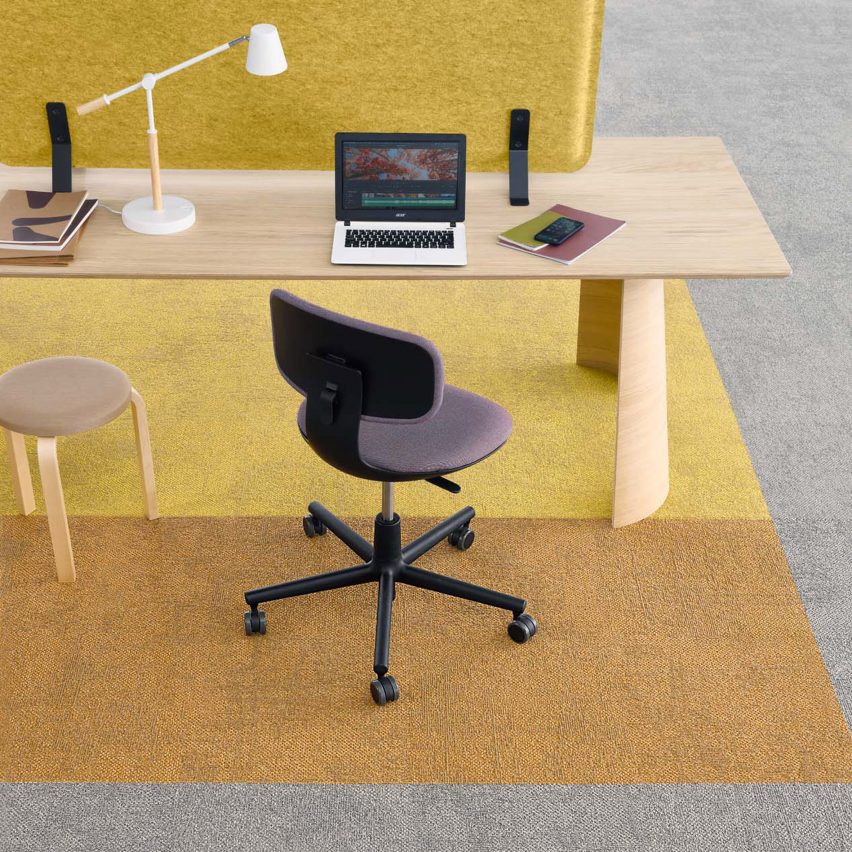 Yellow, orange and grey carget with a desk and office chair by Tarkett