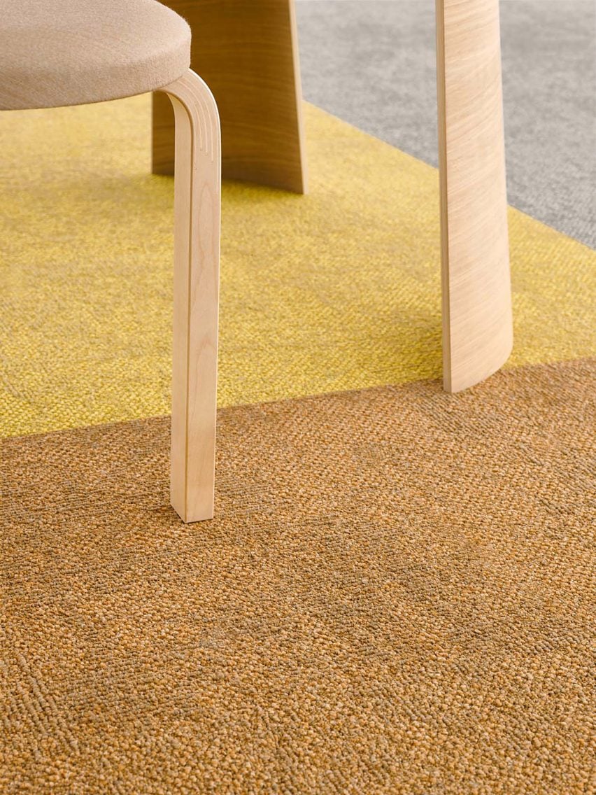 Photograph of yellow and orange carpet beneath table