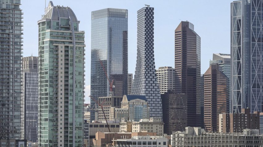 A view of skyscrapers and towers in Calgary, Alberta, focussing on a new curvaceous tower by BIG that bulges from the bottom to a narrow top