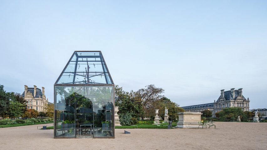 Glass pavilion in front of traditional French garden