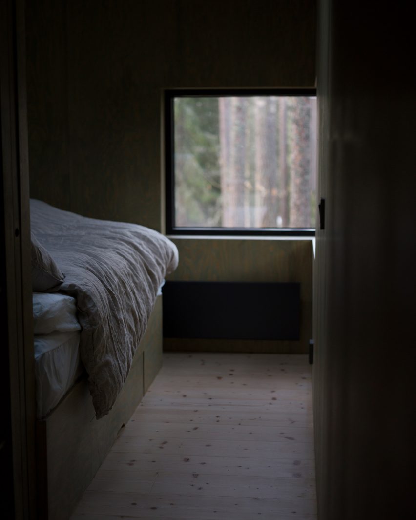 Wood-lined bedroom of holiday cabin