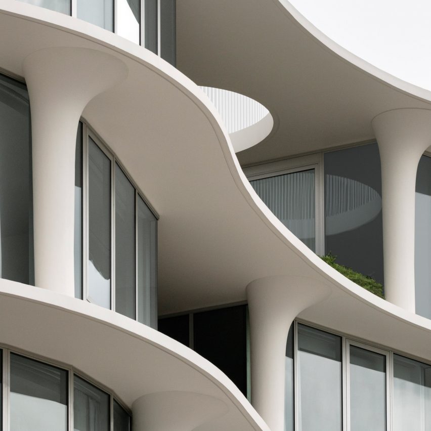 Curved balconies and floorplates of glazed apartment building