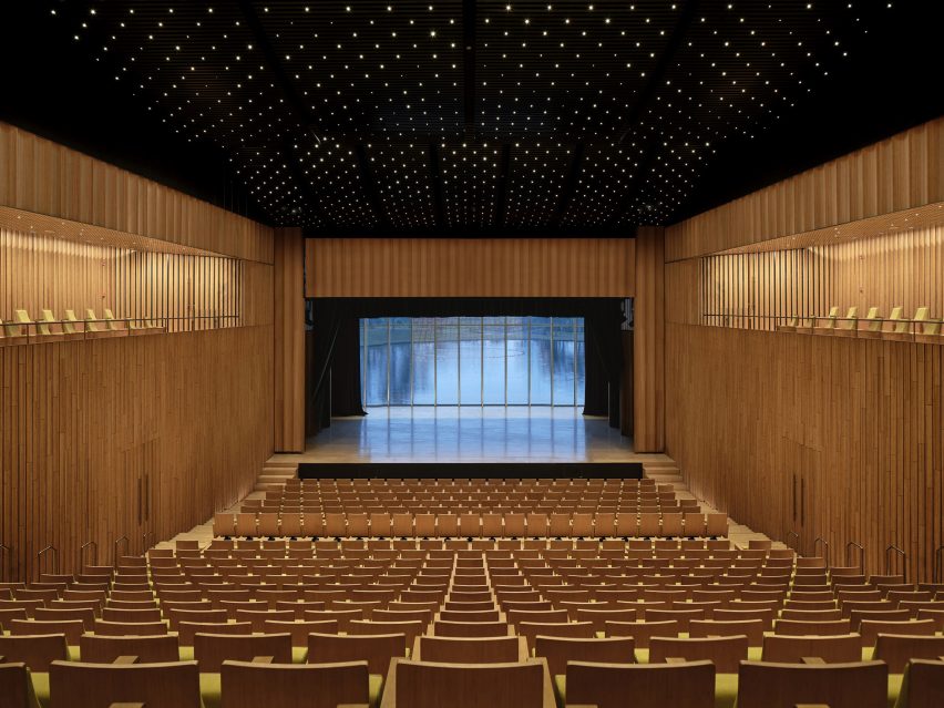 Wood-lined auditorium overlooking lake