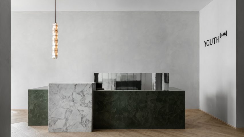Marble reception desk in Youth Lab 3.0 clinic interior design by Nickolas Gurtler