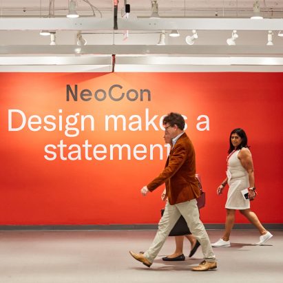 Photo of the NeoCon logo on a red wall