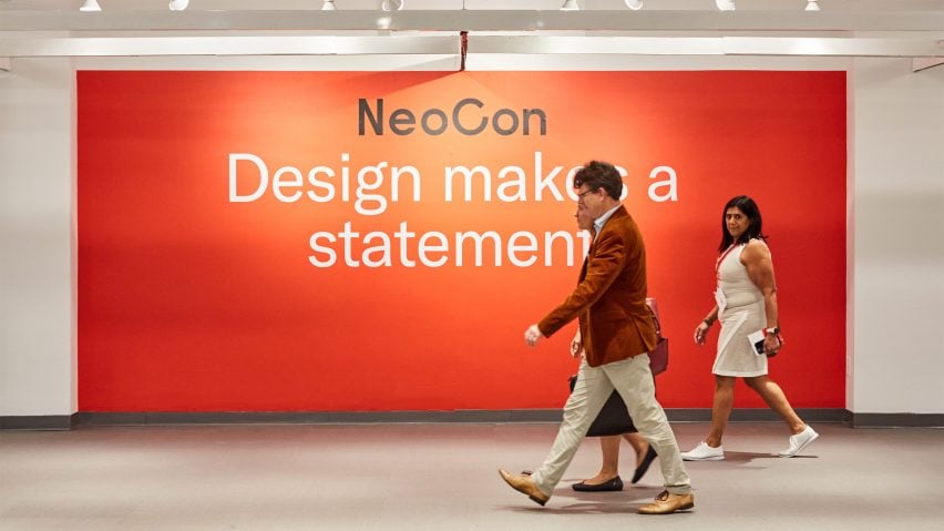 Photo of the NeoCon logo on a red wall