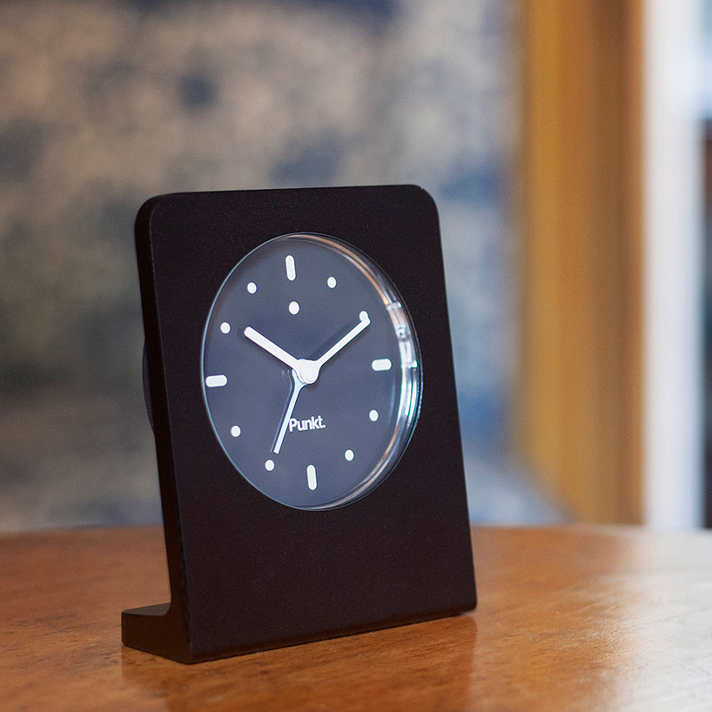 Black minimalist punkt clock with white hands