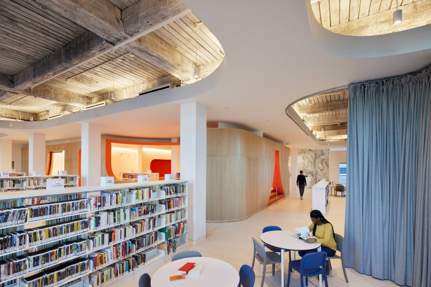 Exposed industrial rafters in modern Brooklyn library