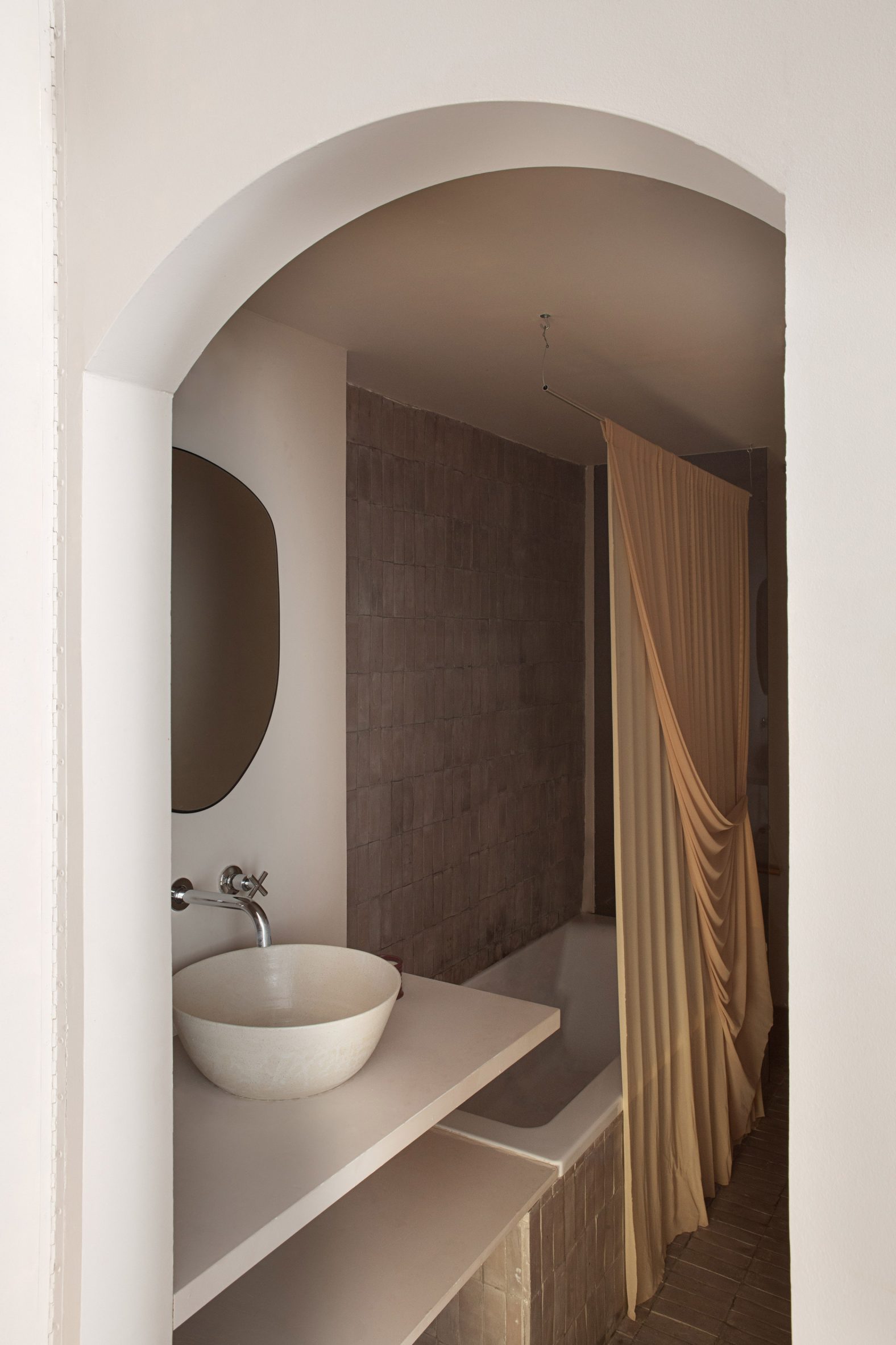 Bathroom with yellow nylon curtain in Madrid apartment by Matteo Ferrari and Carlota Gallo