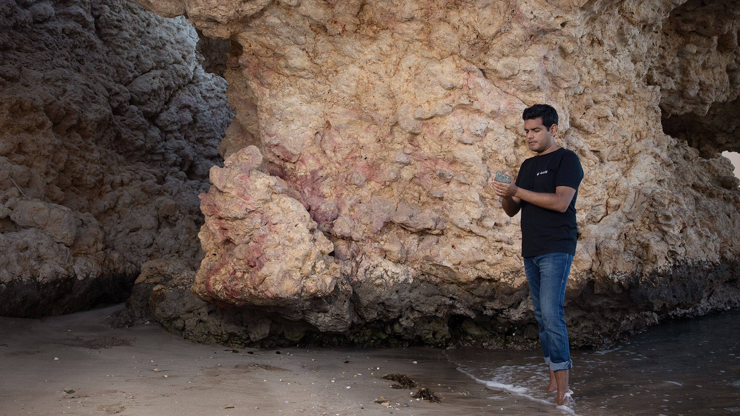 Talal Hasan standing in front of a rock formation