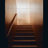 Wood-panelled staircase at The Courtyard Residence by FGR Architects