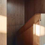 Wood-panelled staircase at The Courtyard Residence by FGR Architects