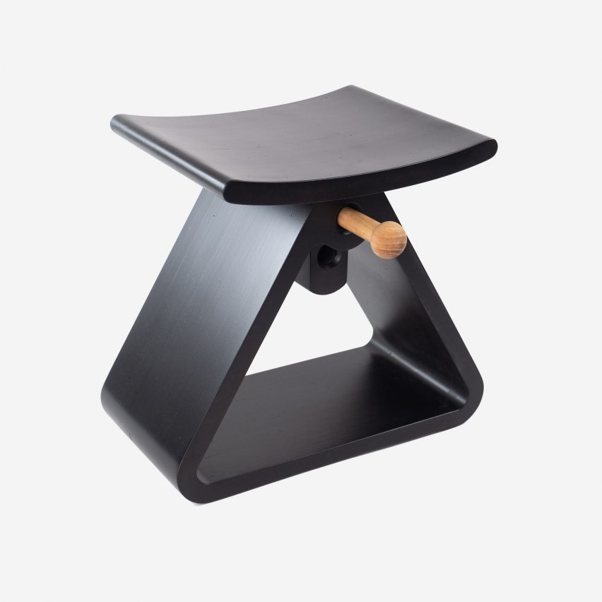 A triangular shaped black stool by Jomo Tariku