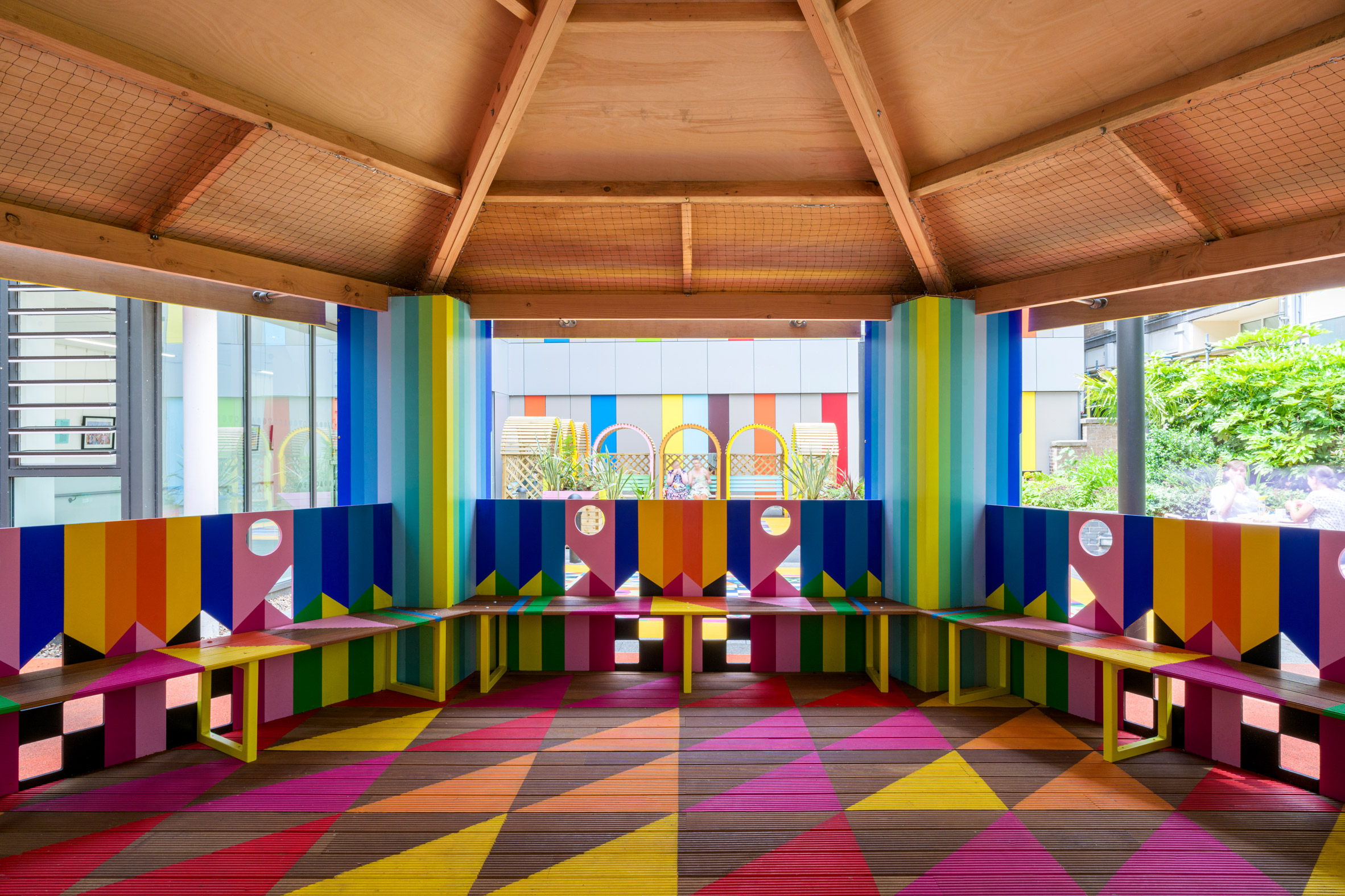 Interior of wooden pavilion by Morag Myerscough