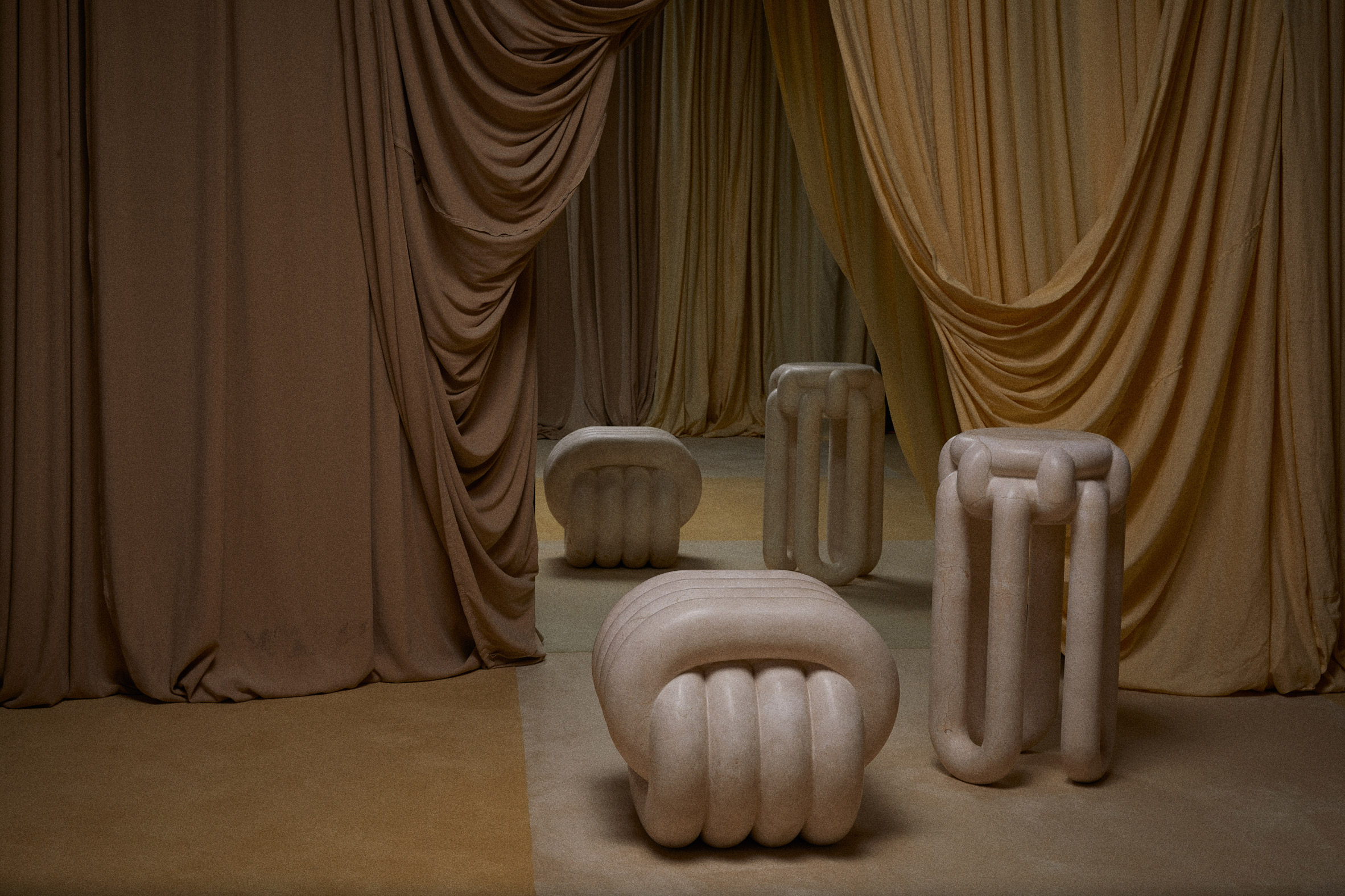 Beige sculpted marble furniture pieces