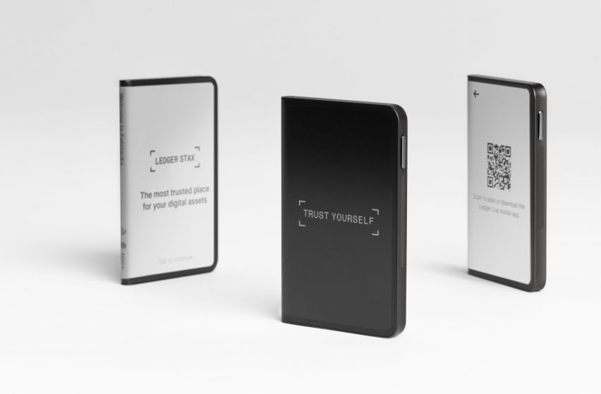 Three small devices with grayscale e-ink screens on each side