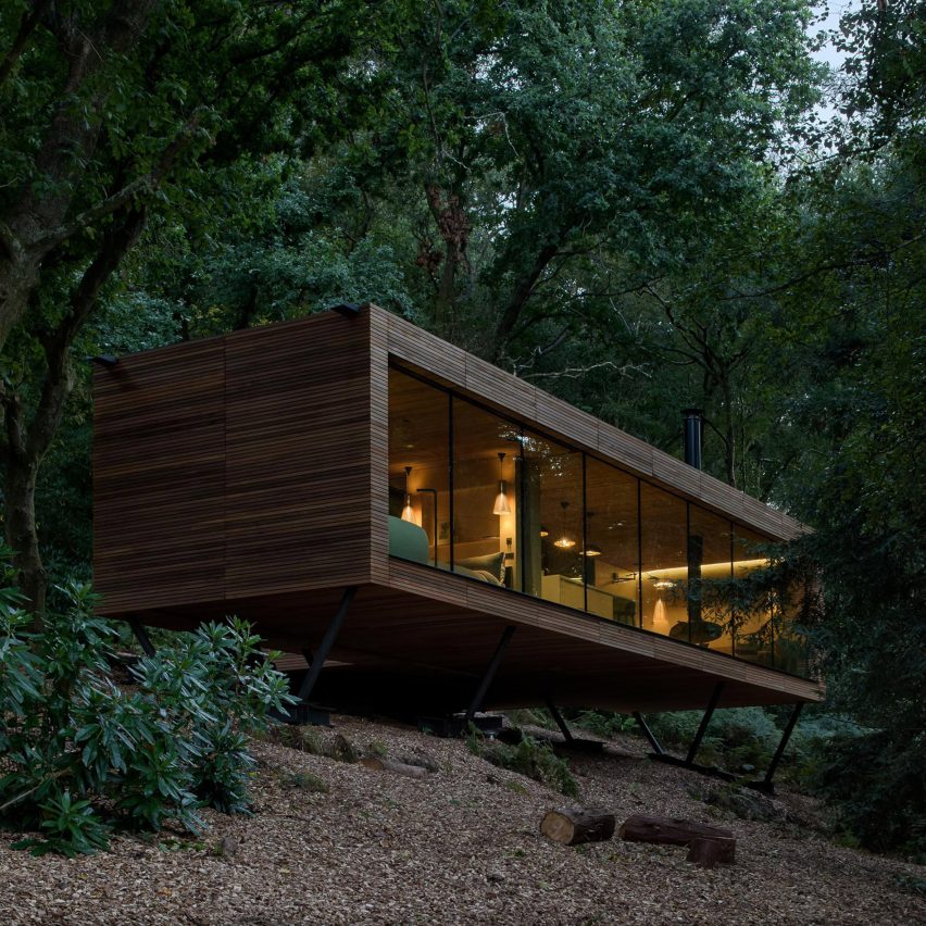 Looking Glass Lodge features glass facades that reflect the surrounding woodland
