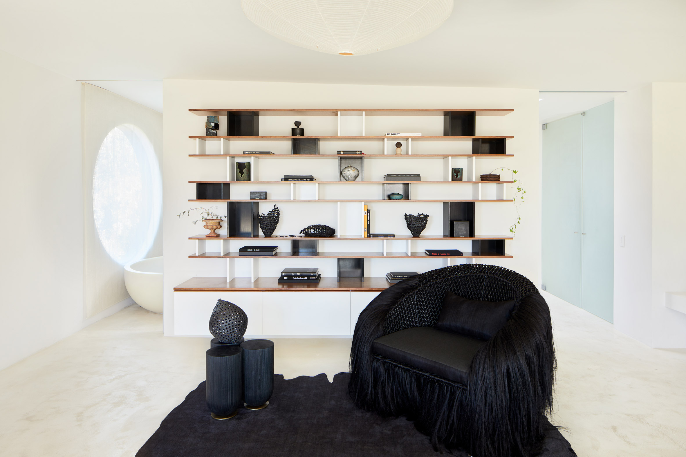 Black furniture in front of storage wall