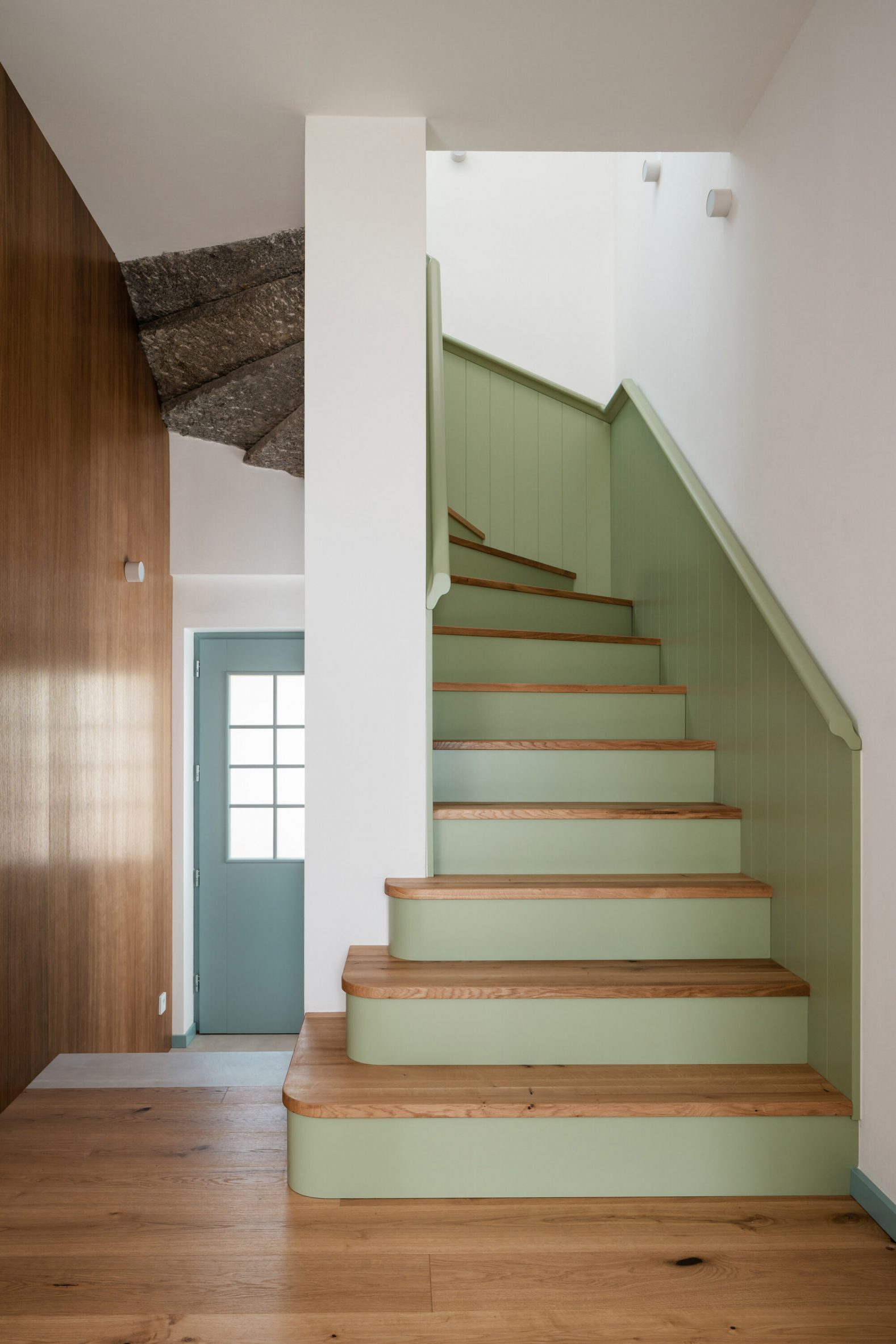 Green staircase at Under The Top house by No Architects