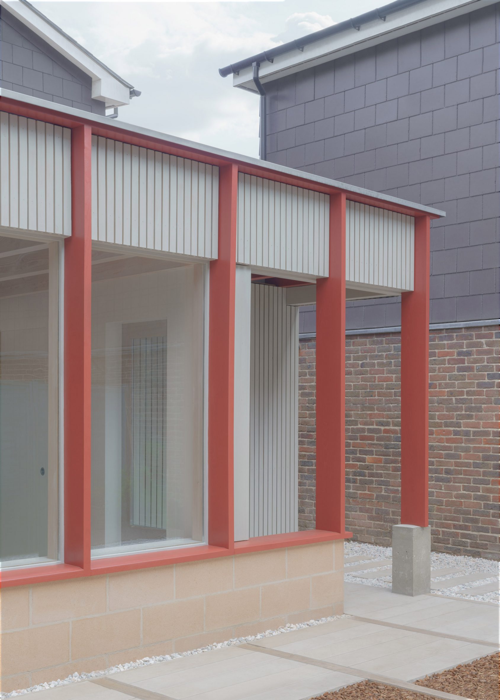 Timber extension with red pillars