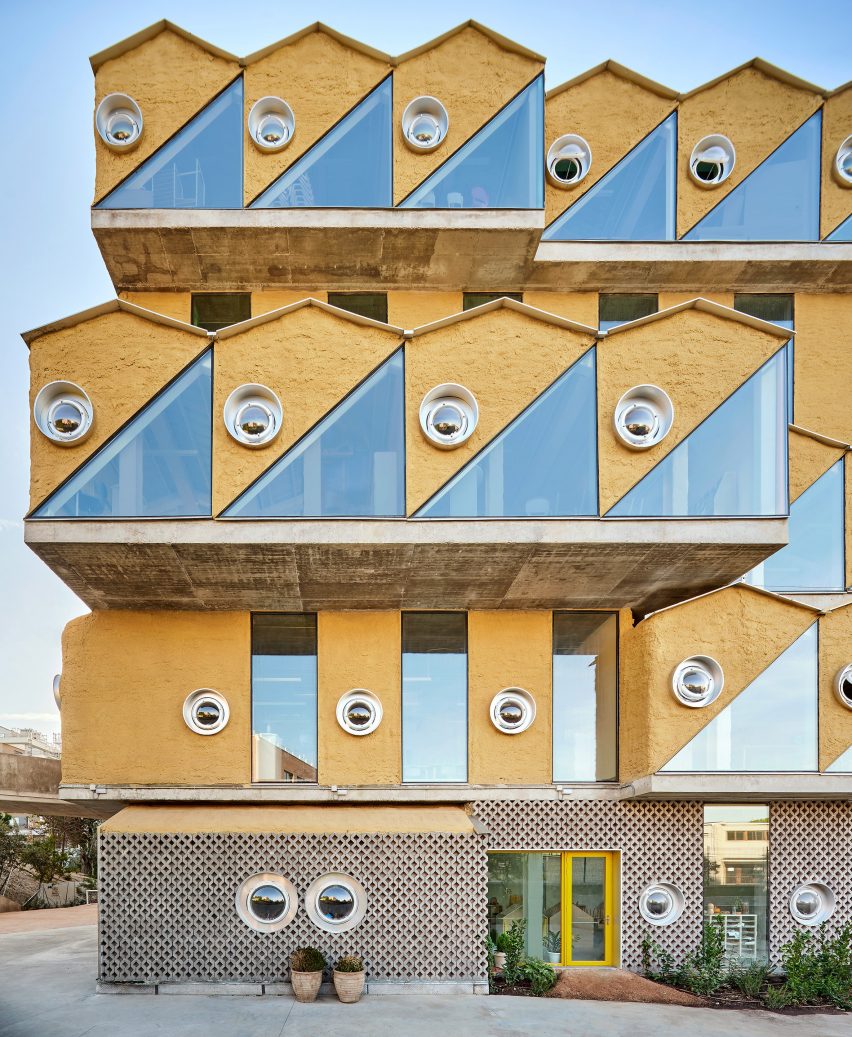 Facade with cork surfaces and porthole windows