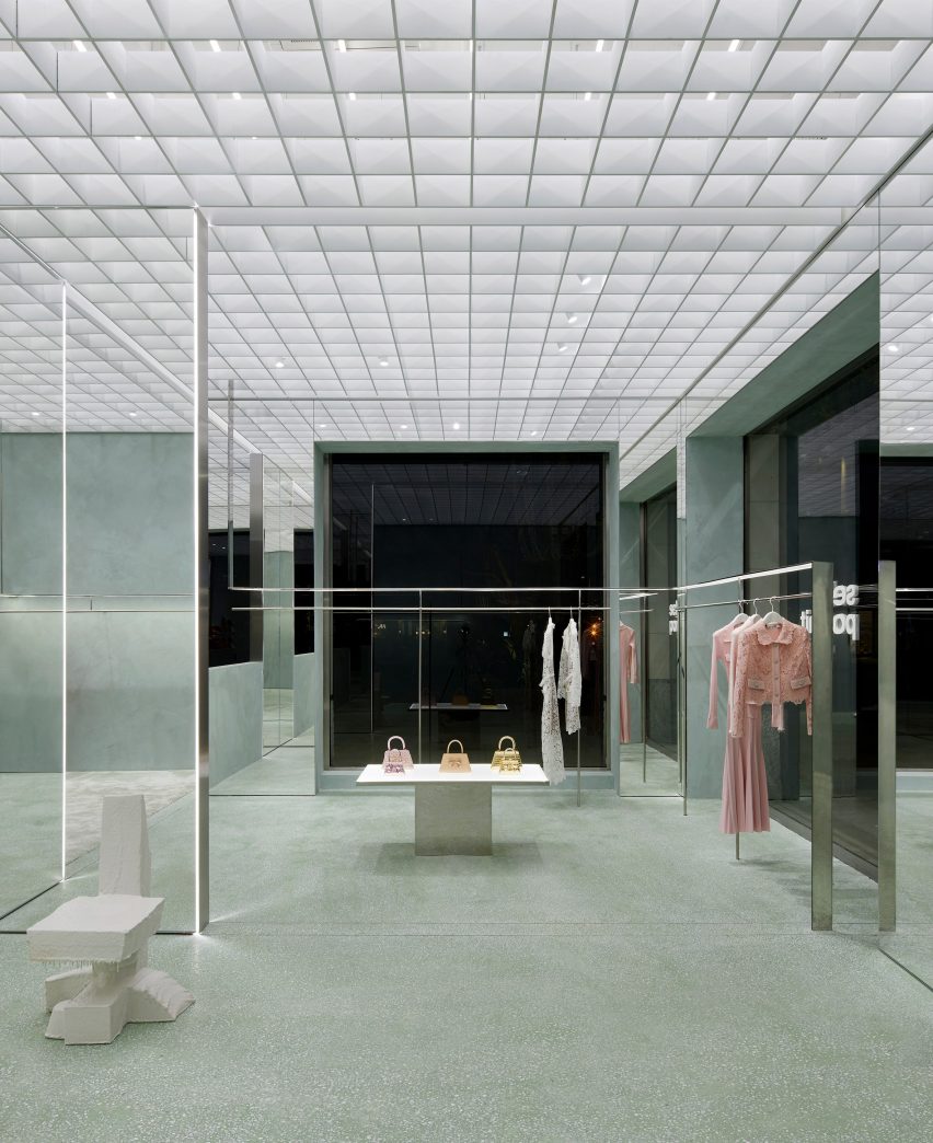 Interior image of the mint-colored Self-Portrait store and its clothes rails