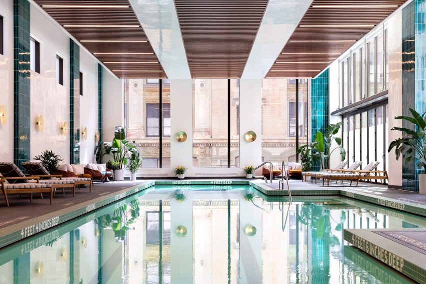 Pool with tiled columns on walls and view of brooklyn