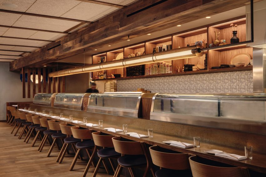 Long sushi bar with linear light fixture