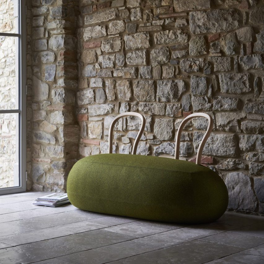 Green pouf-style seat in rustic interior