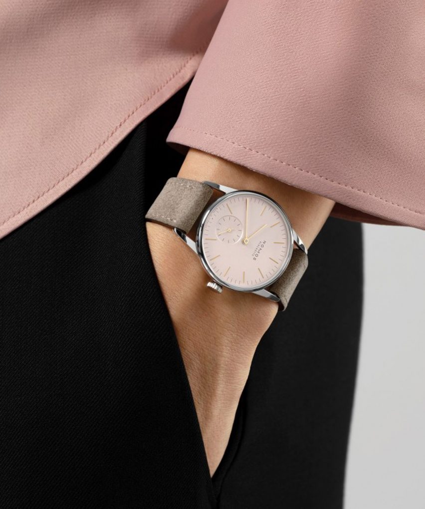 Woman wearing the blush Nomos Glashütte watch