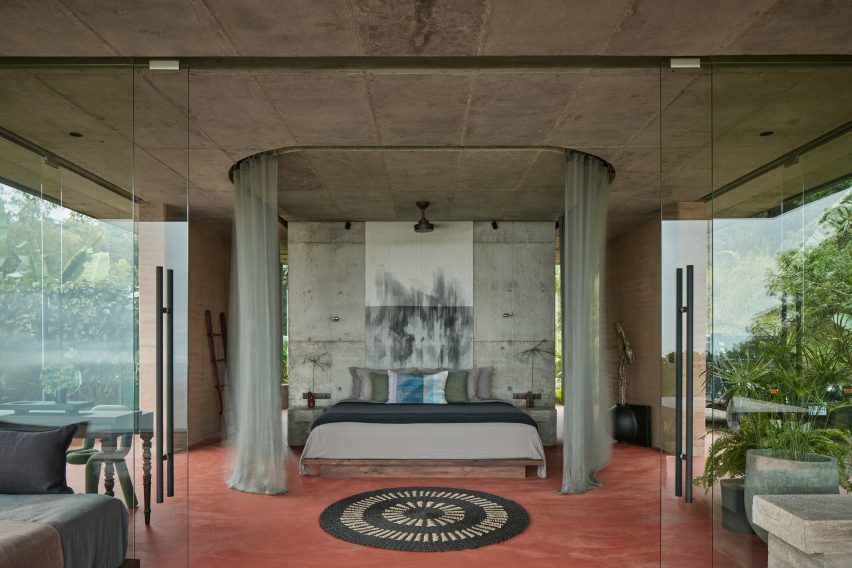 Bedroom with terracotta floor in villa by Formafatal in Costa Rica