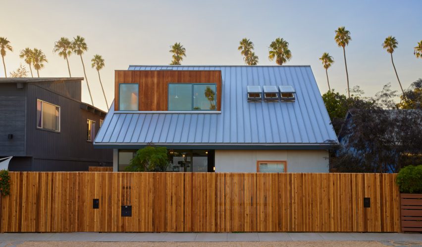 Gabled cottage-style house in Venice Beach with slatted gate around it
