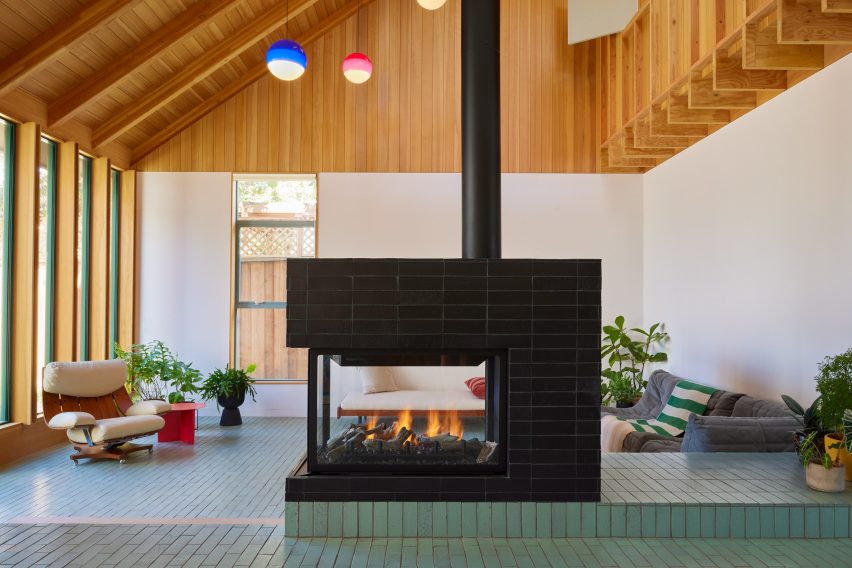 Living room with gable roof and large geometric chimney in the center