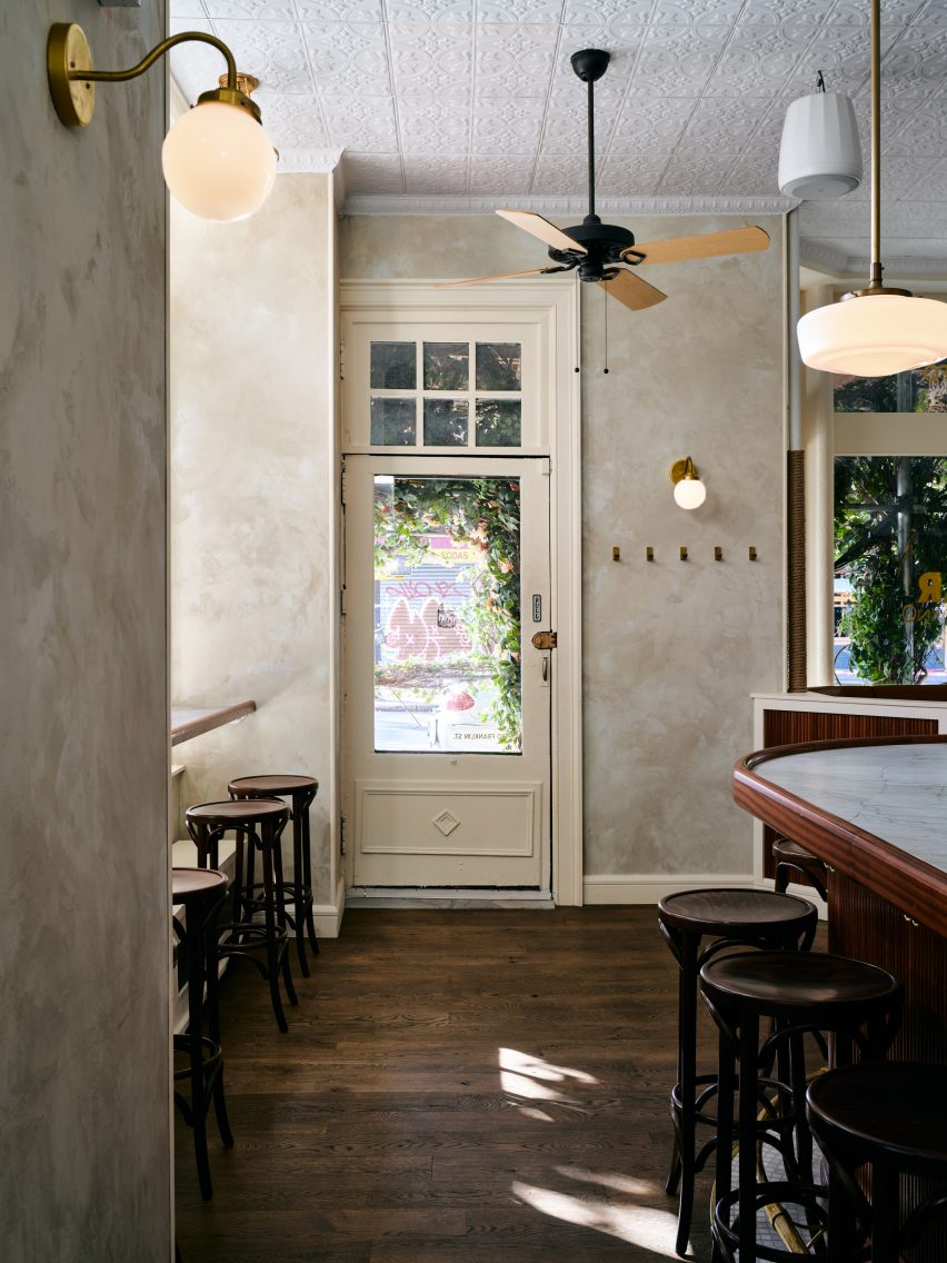 View facing the entrance, with plaster walls and brass lighting