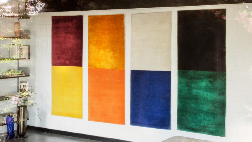 Four dual-colour tapestries on a wall