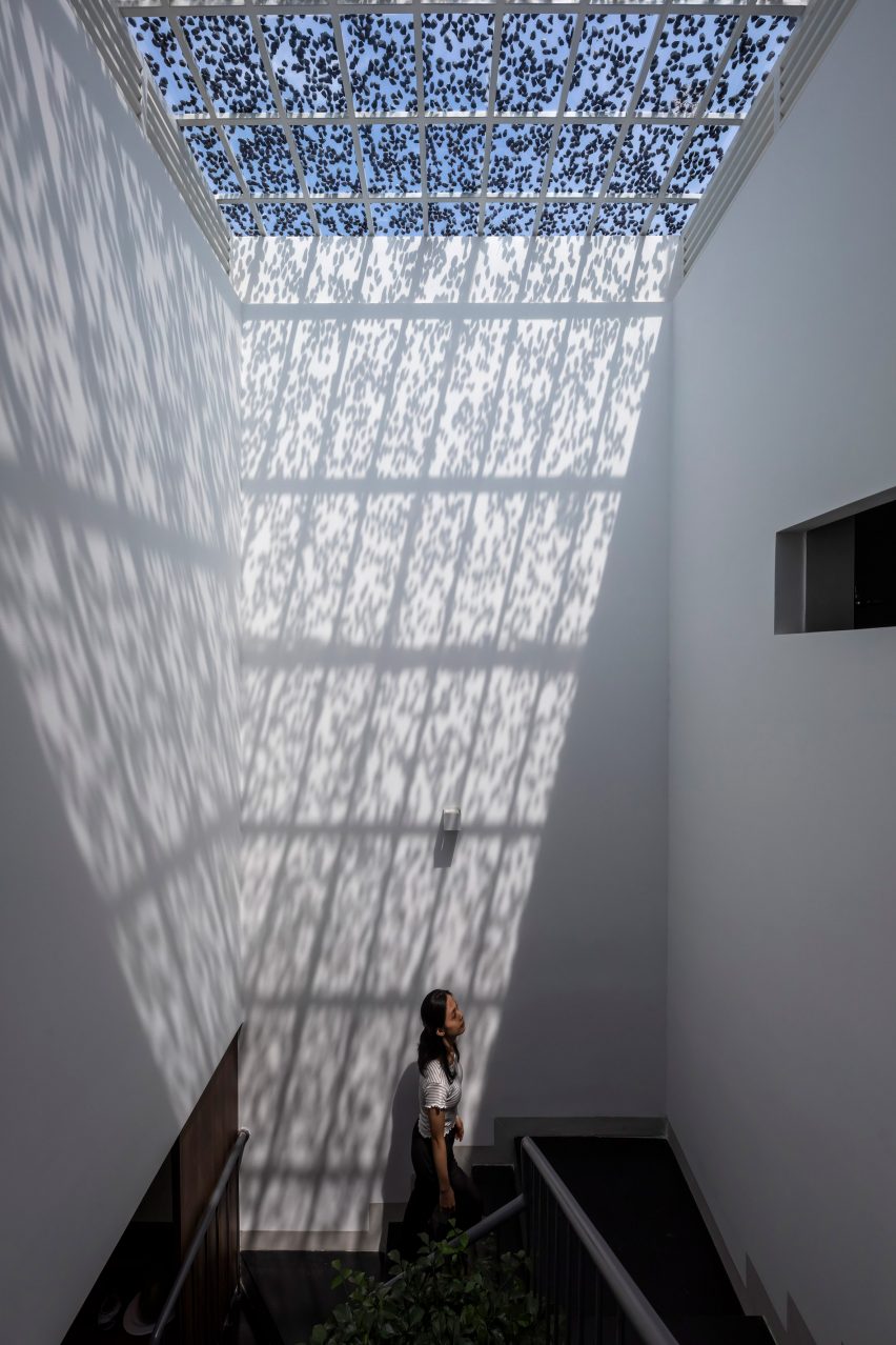 White stairwell lit by skylight