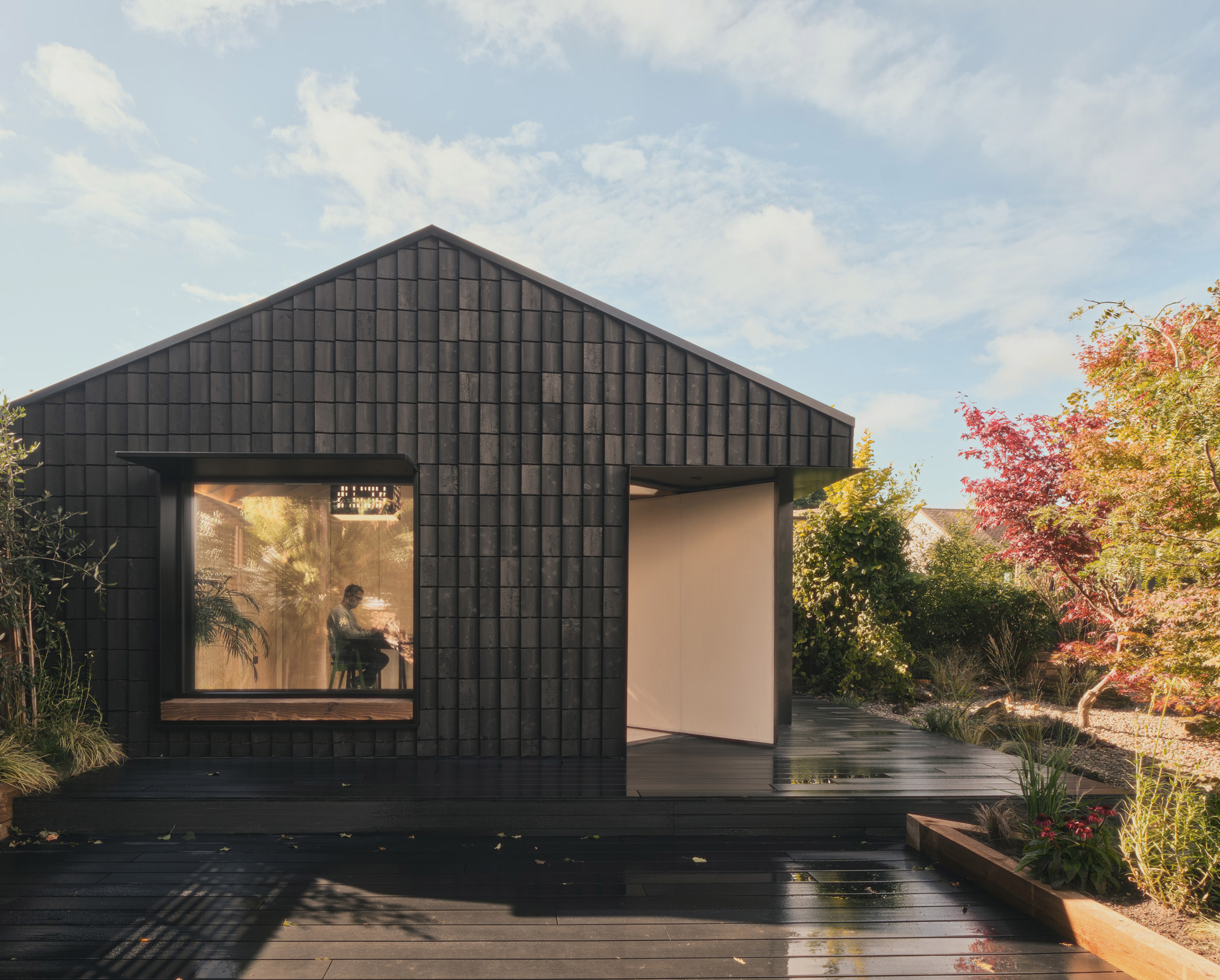 Charred timber facade of Dark Matter garden studio by Hyper