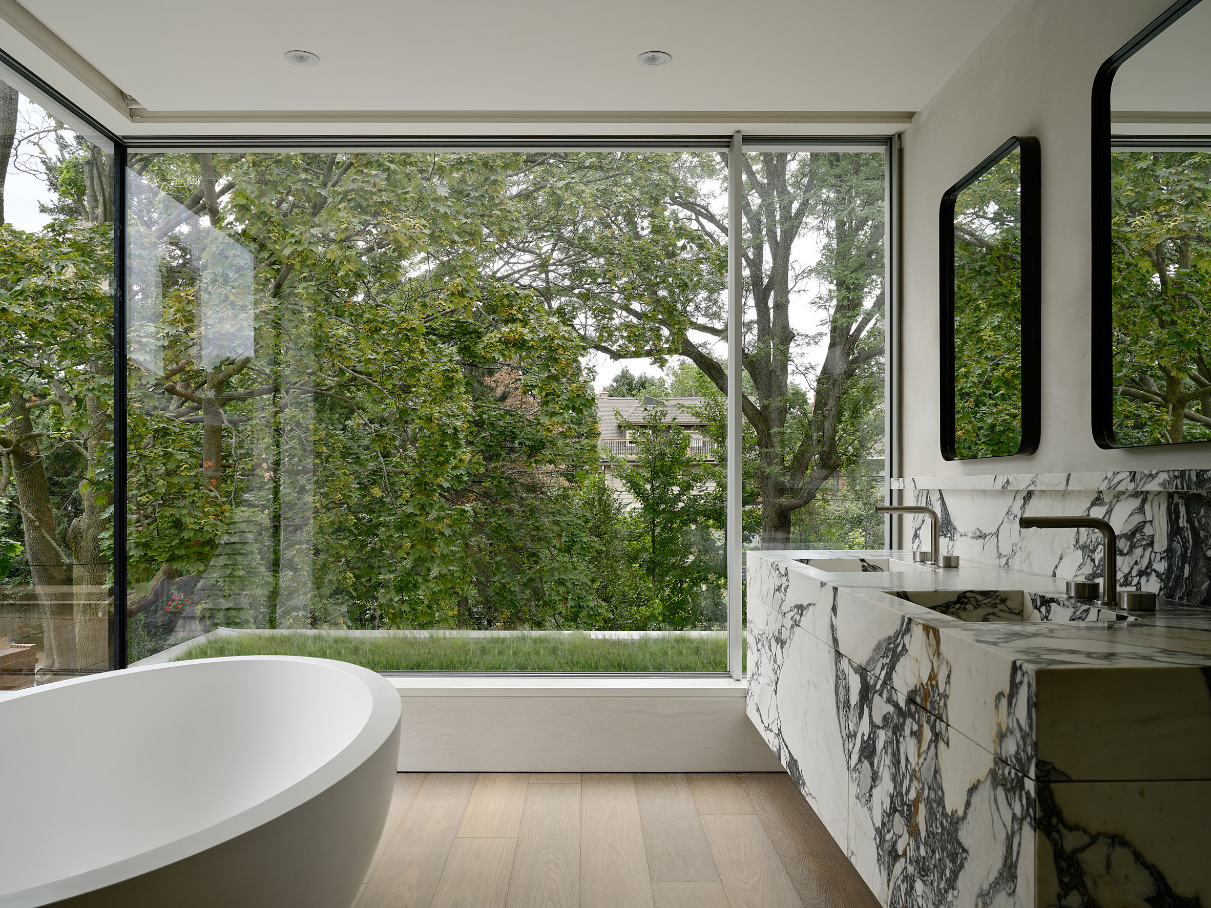 Bathroom with modern details in cottage by Drew Mandel Architects