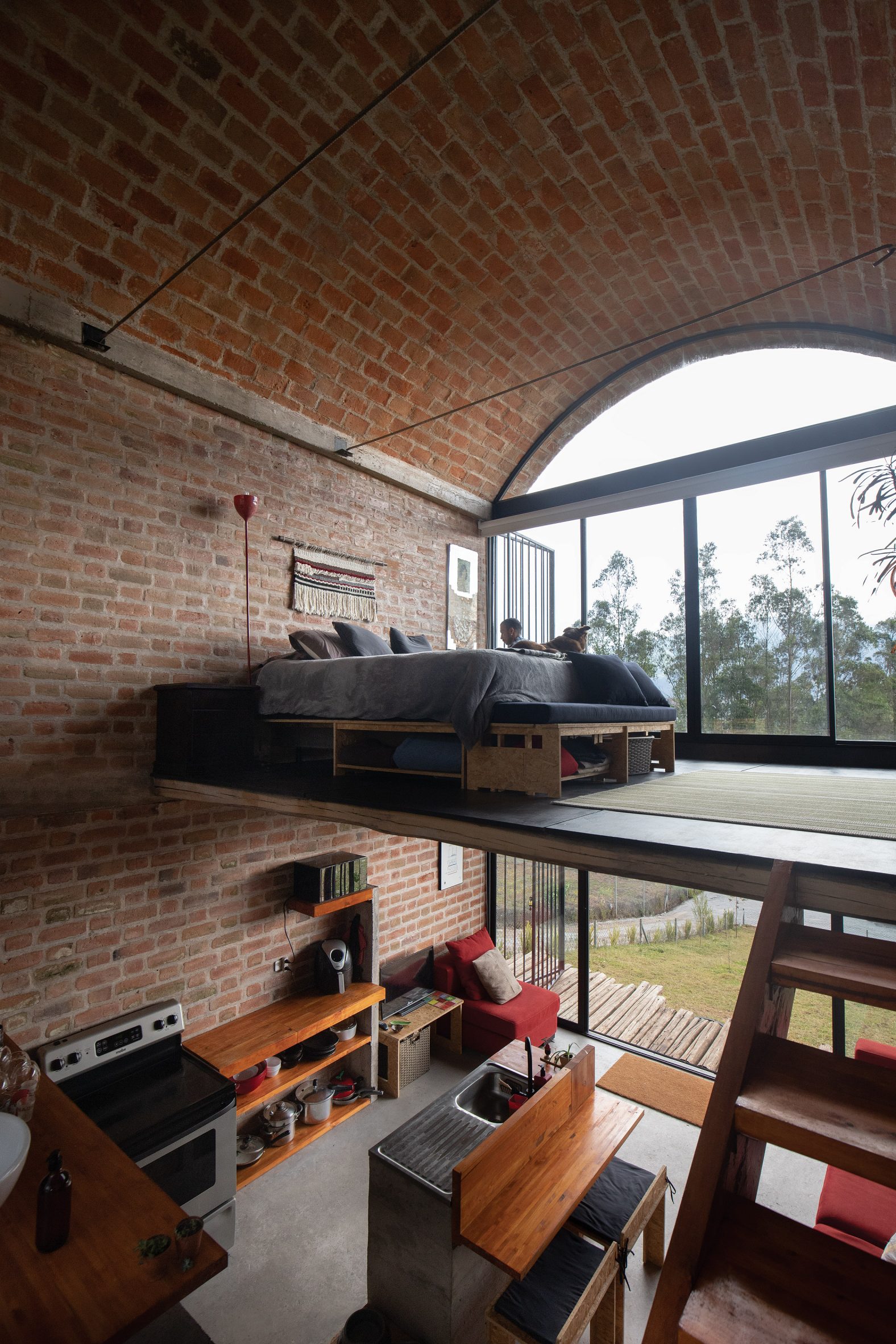 Double bed on mezzanine level of vaulted Ecuadorian house