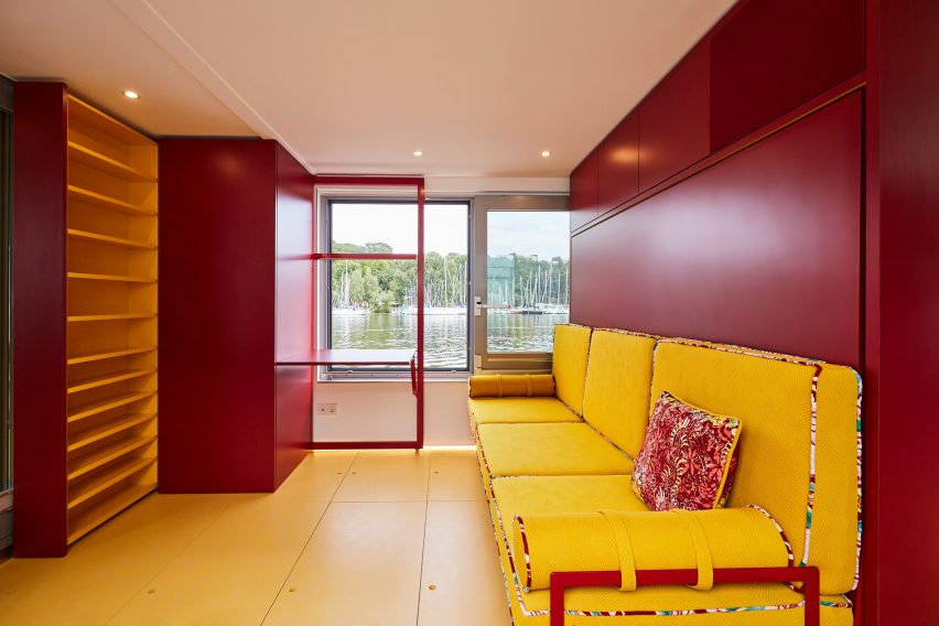 Red living room with yellow sofa