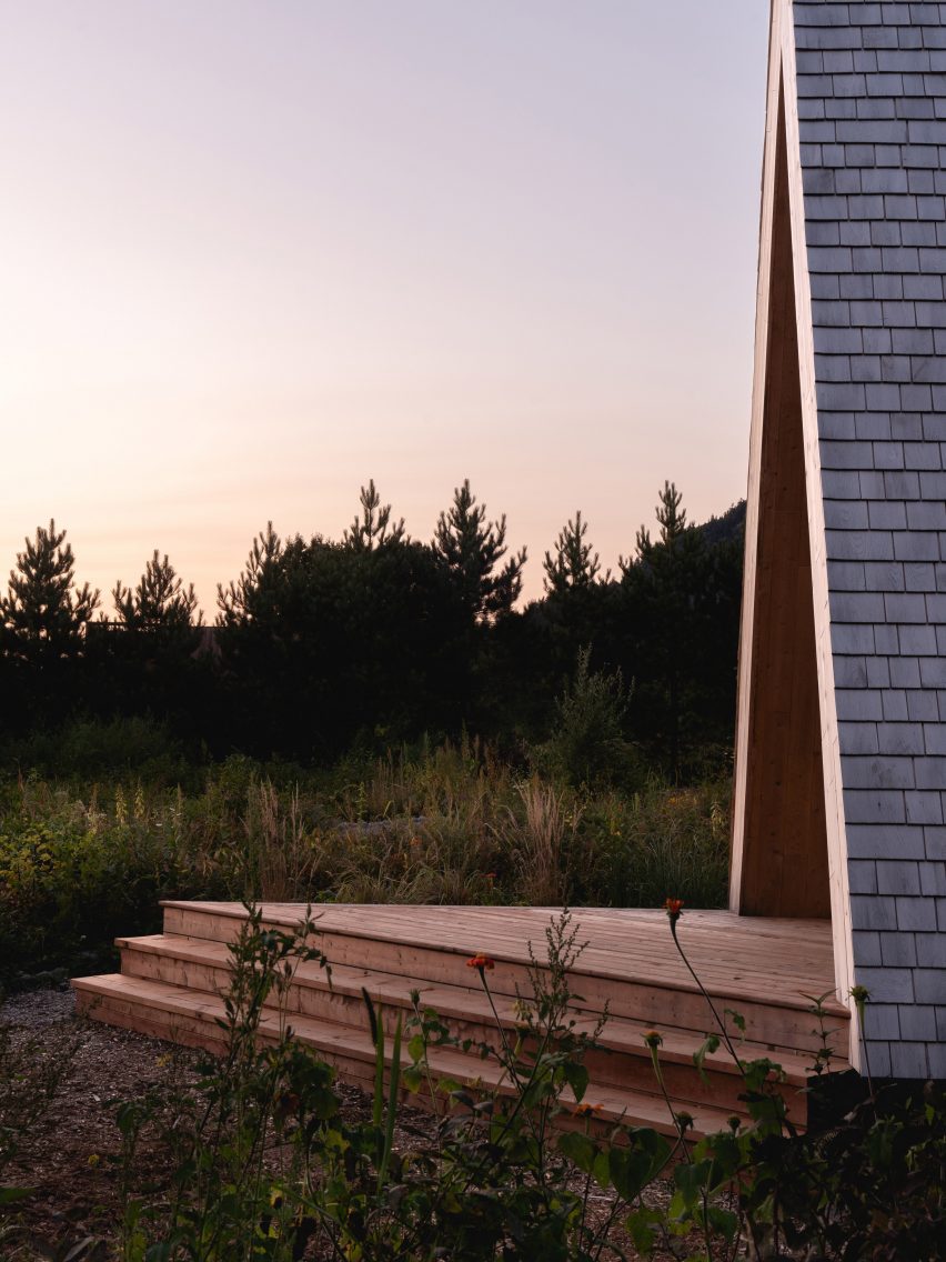 Outdoor deck in front of an A-frame building in the forest