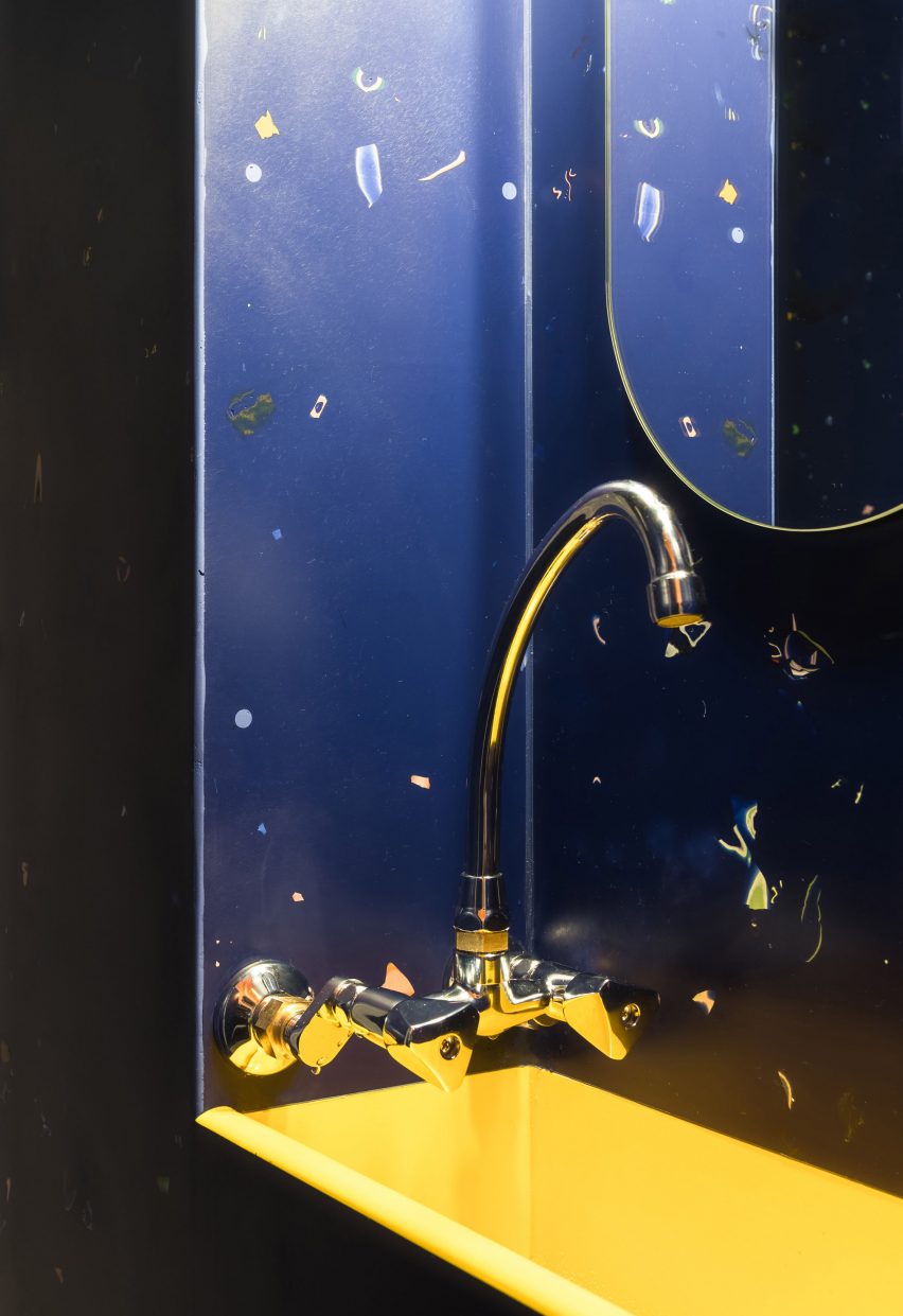 Custom-made yellow sink surrounding blue vanity unit