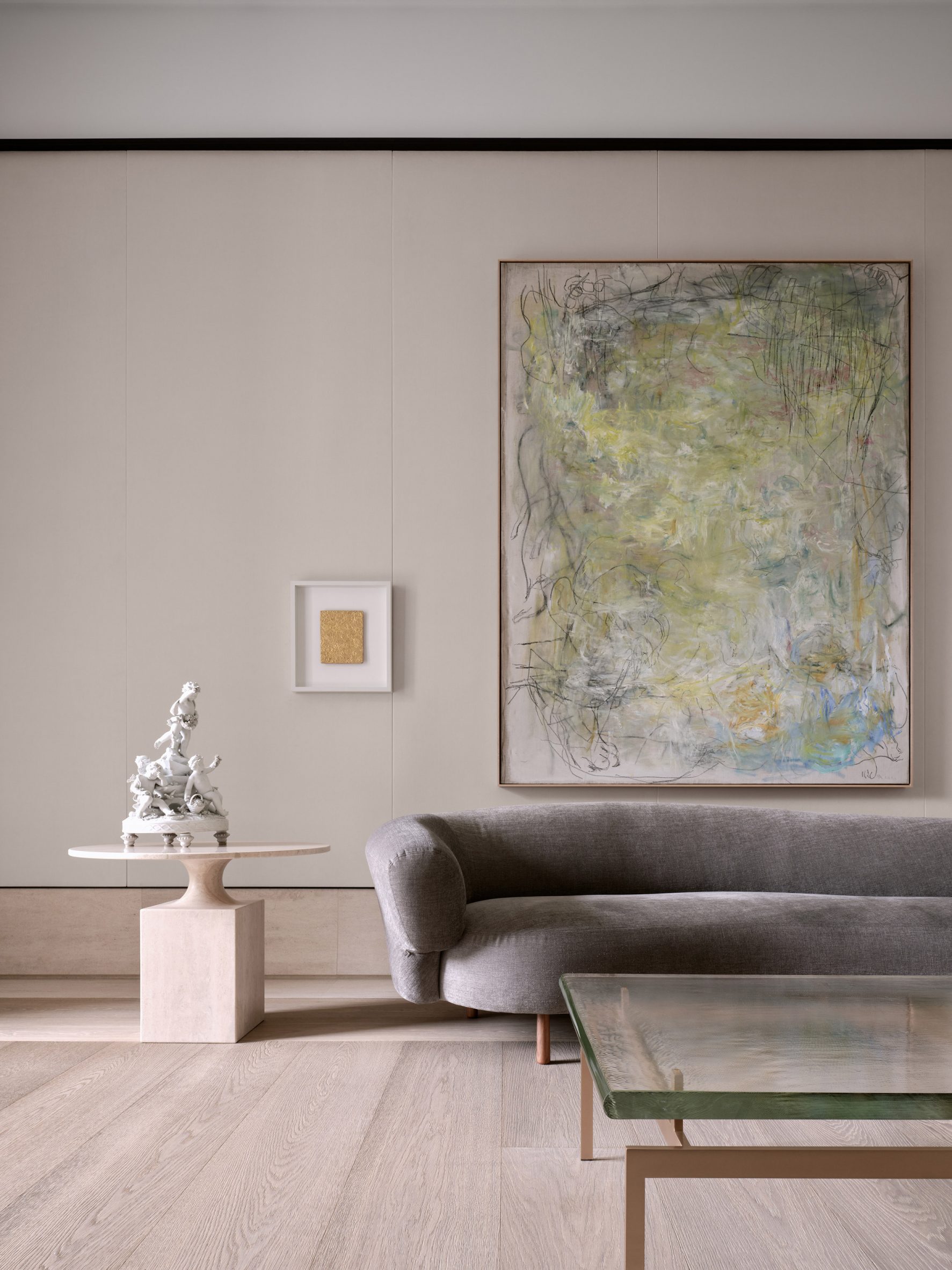 Large contemporary artwork displayed above a grey sofa