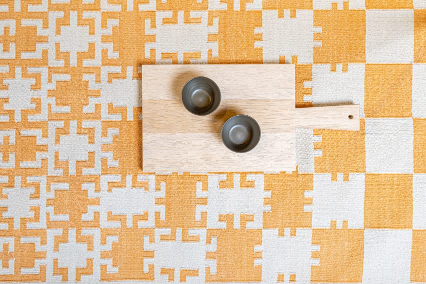 Detail of yellow and off white gridded rug