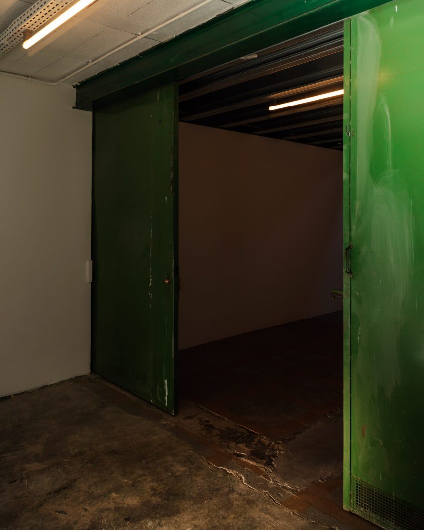 Industrial hall with concrete floors and green metal doors