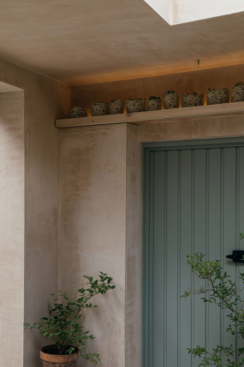 Duck-egg blue door topped with ledge holding ceramics