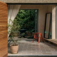 Look through sliding wooden doors into Leyton Garden studio by Paul Westwood